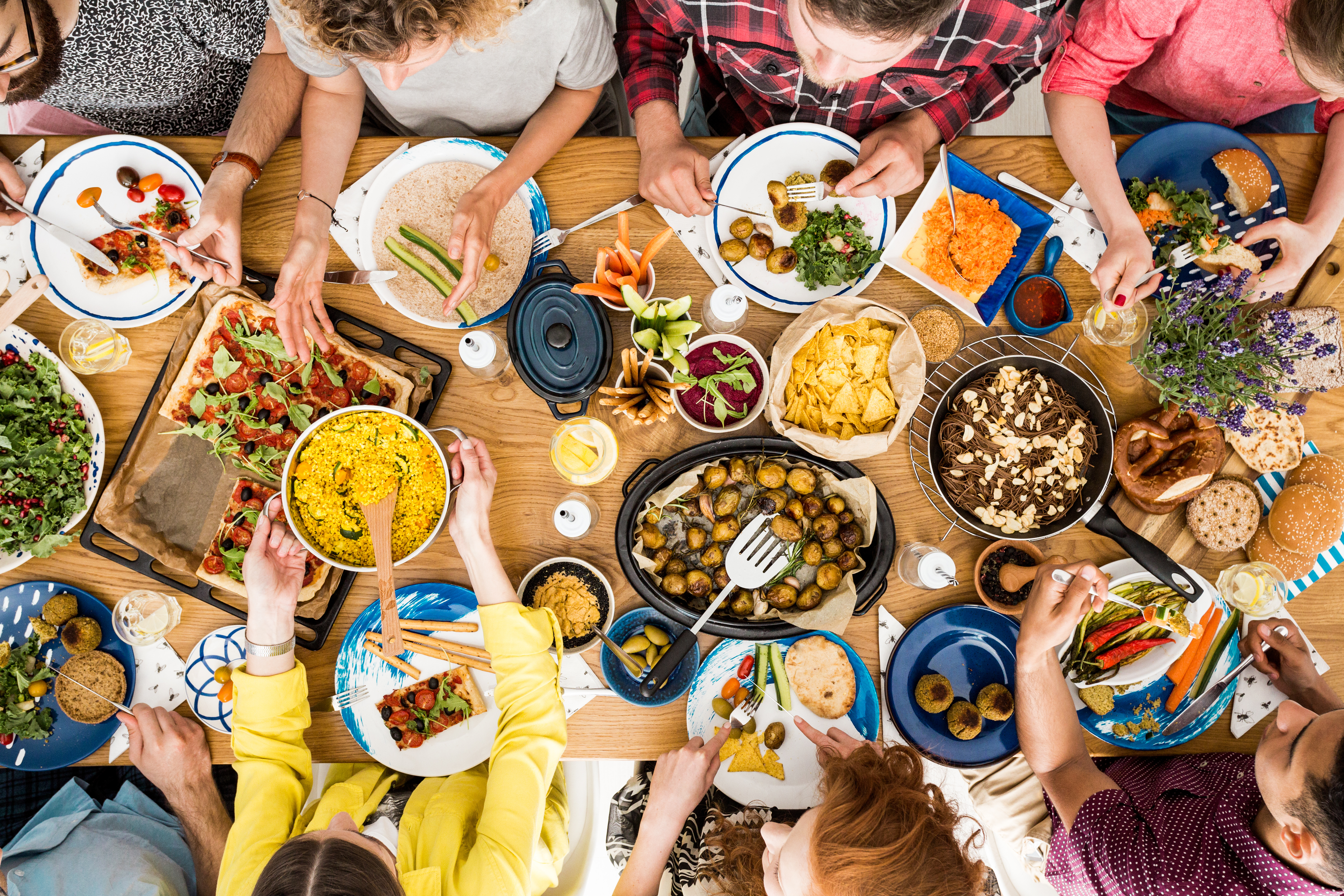 Friends sharing a tasty meal together during a restaurant fundraiser.